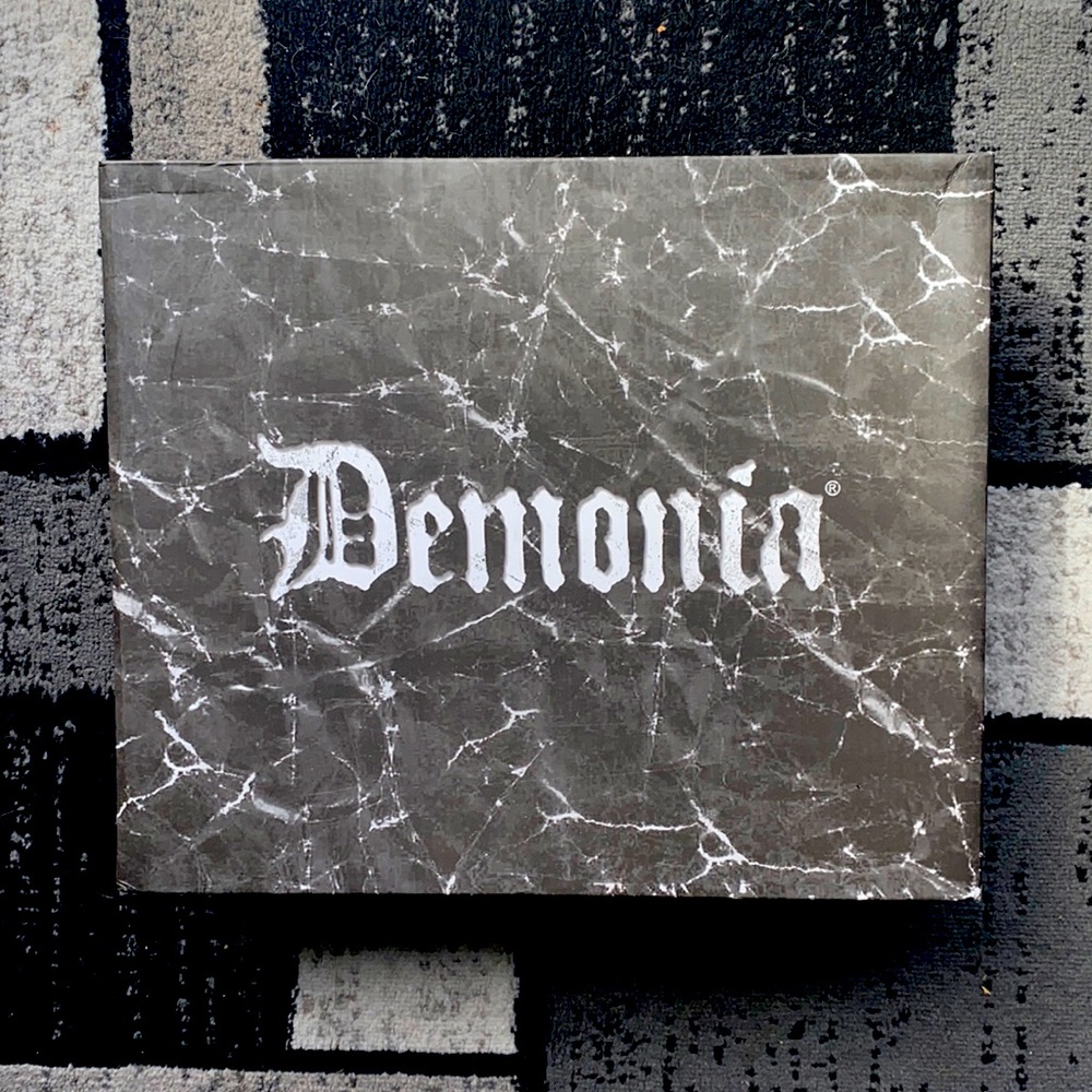Demonia white platform shoes.
